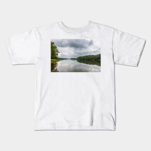 Cloudy sky over calm lake Kids T-Shirt
